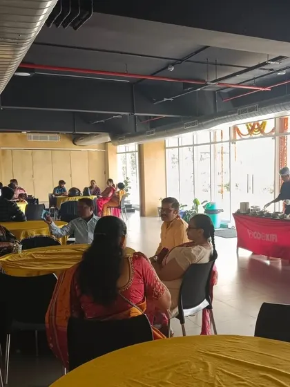 A lively atmosphere at a clubhouse event we catered, with guests seated and enjoying the food and conversation.