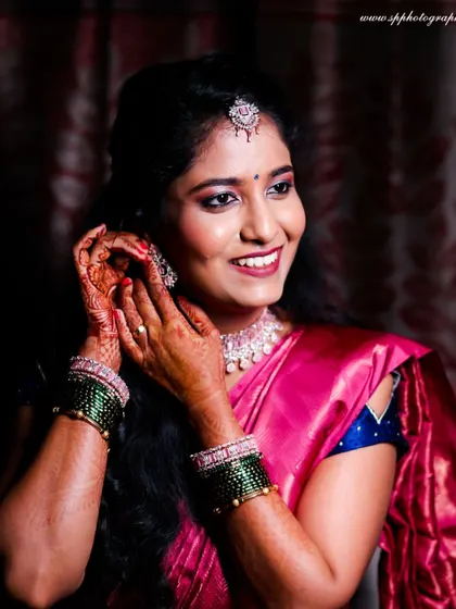 A beautiful "getting ready" shot of the bride. We capture the final touches, like putting on earrings, which are part of the exciting build-up to the ceremony.