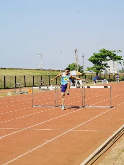 An athlete clears a hurdle with precision during the PDP Athletics Championships. This image showcases the high level of skill and technique on display at our competitive events.