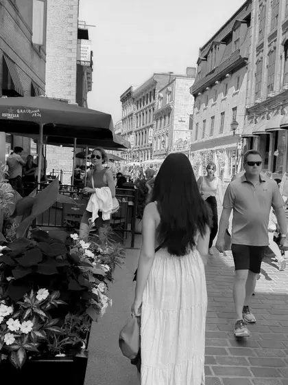 A black and white photo walking through the bustling streets of Old Montréal, creating a timeless feel.