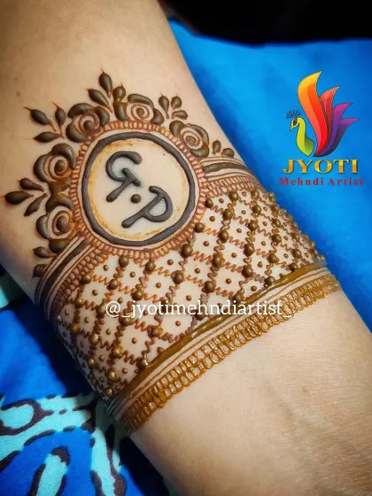 A simple yet elegant cuff design featuring the initials 'G.P.' surrounded by a floral border and delicate dot work. I can personalize any design with your initials.