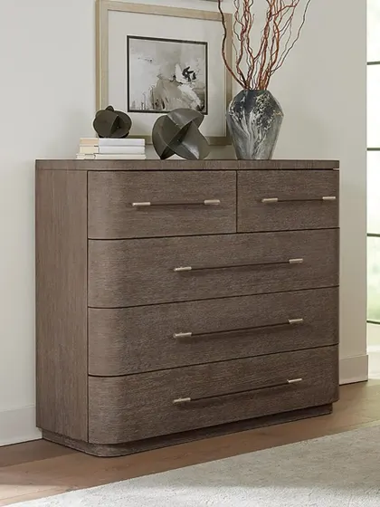 Softly sophisticated, this modern bachelor's chest features rounded corners and a plinth base. Crafted from oak veneers, it offers five self-closing drawers with the top two felt-lined and the bottom one cedar-lined.
