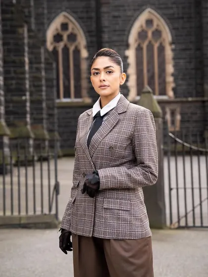 The full look of the custom plaid suit, set against a beautiful architectural backdrop in Melbourne.