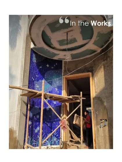A stunning mosaic wall being installed on-site. This image captures the moment where a key artistic element is integrated into the architecture, a pivotal point in the construction process.