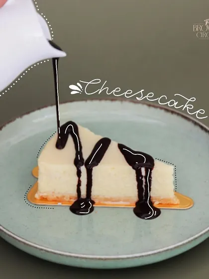 Another look at our classic cheesecake, this time generously topped with a decadent chocolate sauce. You can customize your slice to make it your own.