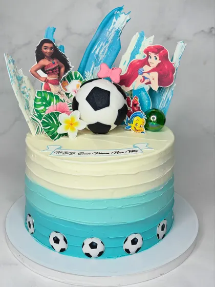 When the birthday kid can't decide on a theme, why not combine them? This cake features Moana, The Little Mermaid, and soccer, all on one ocean-themed cake.