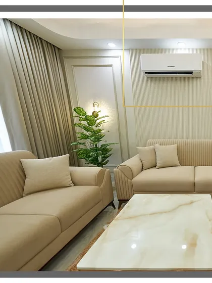 A close-up of the fluted wall paneling and simple, elegant curtains. These details contribute to the room's sophisticated and uncluttered feel.