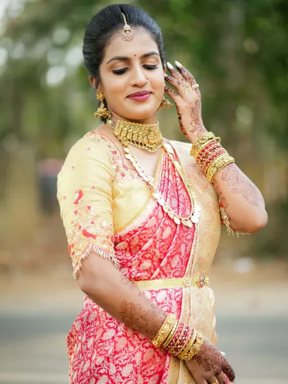 A graceful pose from the same client, showing off her intricate henna and the glowing finish of her makeup.