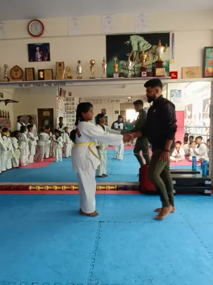 A student receives her yellow belt.