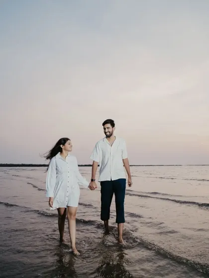 A quiet walk in the water as the sun sets. The soft, fading light creates a beautifully romantic and peaceful atmosphere.