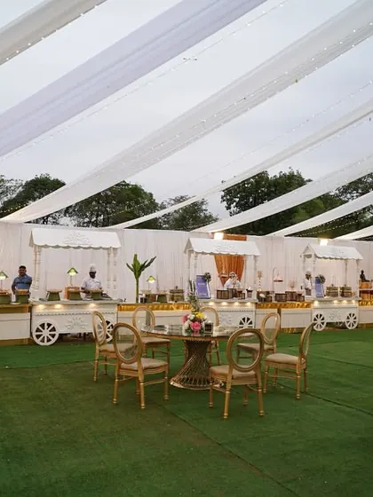 A full view of the outdoor catering area, showing how the food carts and seating are integrated seamlessly into the overall event design under a beautifully draped tent.