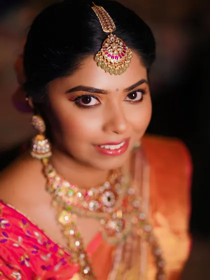 A close-up portrait of the bride, her smile and beautiful makeup shining brightly.