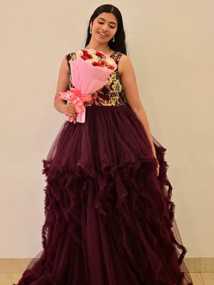 A sweet moment with a bouquet of roses. The soft, romantic makeup is perfect for this princess-like gown and overall look.