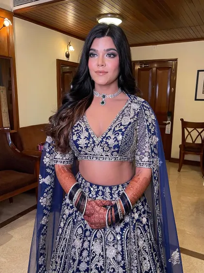 A stunning sangeet look in a deep blue lehenga. I styled the hair in soft waves to complement the glamorous outfit.