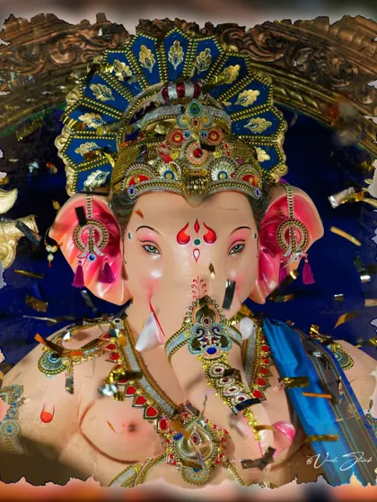 A frontal close-up of the Sanpada Cha Raja, with confetti adding to the festive feel.