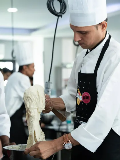 A chef from Marriott demonstrates a technique during the Pastry Symposium held at our academy. We are proud to partner with industry leaders to provide advanced training.