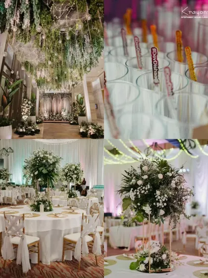 A look at the beautiful reception decor, featuring lush green and white floral arrangements, elegant table settings, and personalized drink stirrers.