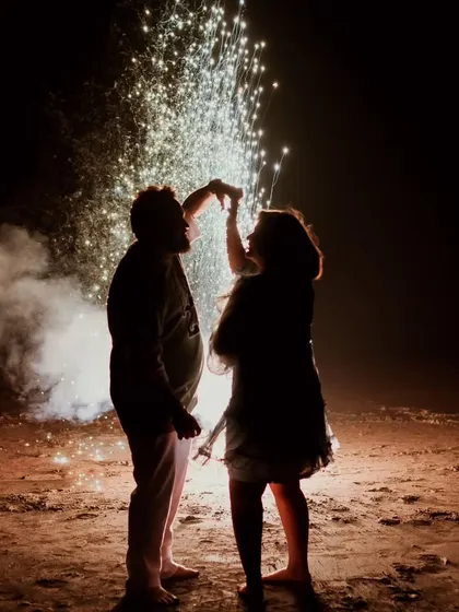 A silhouette of a couple dancing under a shower of fireworks. This celebratory and dramatic shot is perfect for capturing the excitement and magic of your love story.