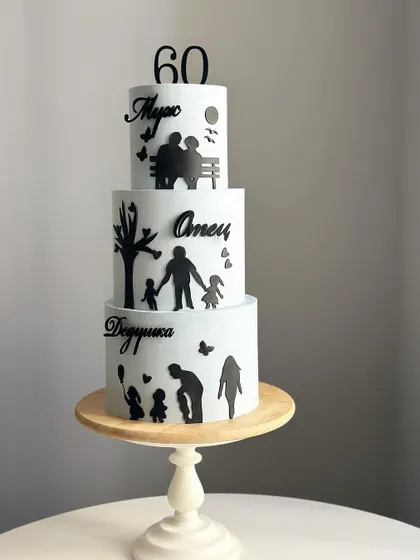 A touching three-tiered cake for a 60th birthday. Each tier features silhouettes representing different stages of life: as a grandfather, a father, and a husband.