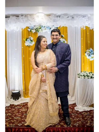 A classic portrait of the couple on their Sangeet stage, beautifully dressed and ready to celebrate with their loved ones.