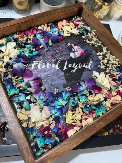 The floral layout is the first step in bringing a keepsake to life. Here you can see the arrangement of vibrant orchids and other flowers before the resin is poured, setting the stage for the final piece.