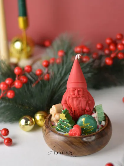 My Santa Wooden Bowl Candle, featuring a detailed Santa figure surrounded by tiny wax gifts and trees. It's a charming and rustic centerpiece for the holiday season.