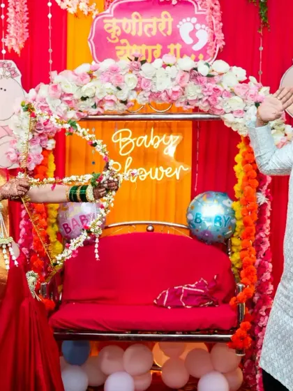 A fun moment from a "dohale jevan" or Maharashtrian baby shower. The mom-to-be is dressed in a traditional saree and participates in a playful ritual.