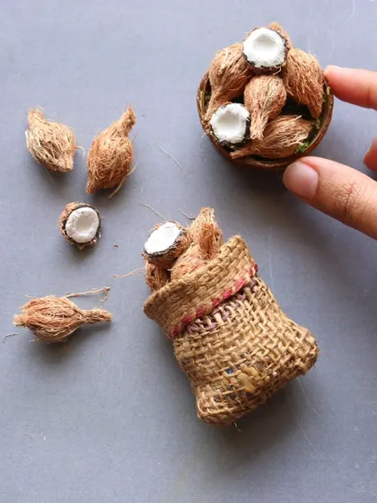 A close-up of the miniature sack of coconuts.
