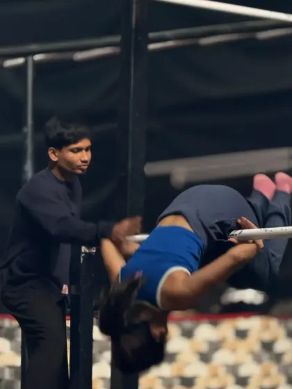 Safely guiding a student through a front roll on the bar. I make sure every member learns new skills with the right technique.