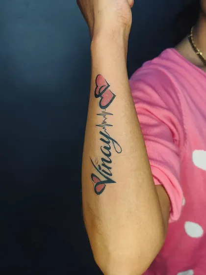 The color version of the "Vinay" heartbeat tattoo. A little bit of red shading in the hearts makes the design stand out on the skin.