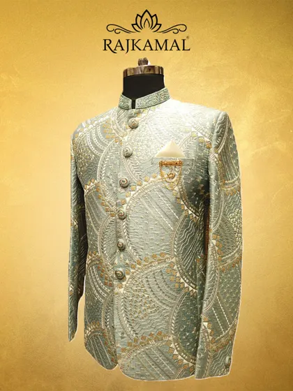 A side angle of the pastel green Jodhpuri, highlighting the pocket square and the beautiful golden and white threadwork.