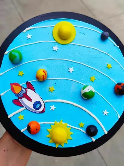A solar system cake showing all the planets orbiting the sun. This is a fun and educational design for any aspiring astronaut's birthday.