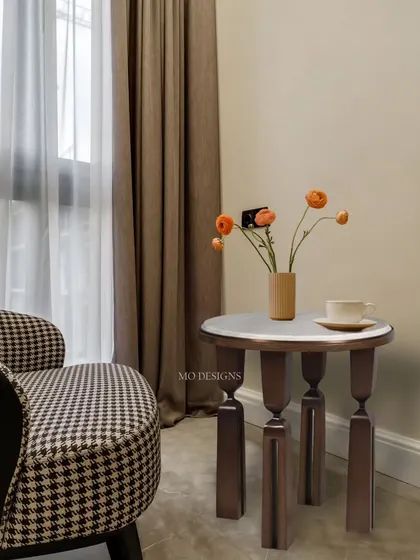 This captivating side table is a true statement piece. It features a beautiful shagreen top for texture and interest, while the sculptural bronze-patina brass legs add a touch of glamour and artistry.