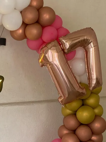 A close-up on the rose gold foil number balloons, a popular choice for milestone birthdays.