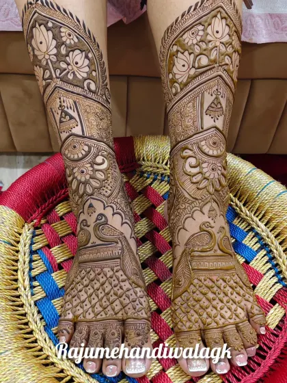 A very full and intricate foot design, with peacocks and architectural elements covering the entire foot and ankle.