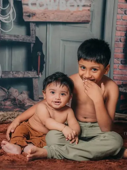 A sweet and candid moment between two brothers. I love capturing the genuine connection in sibling portraits.