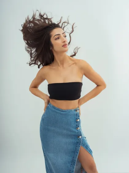 A powerful pose with a focus on the hair's volume and movement. The makeup is kept minimal to balance the drama of the shot.