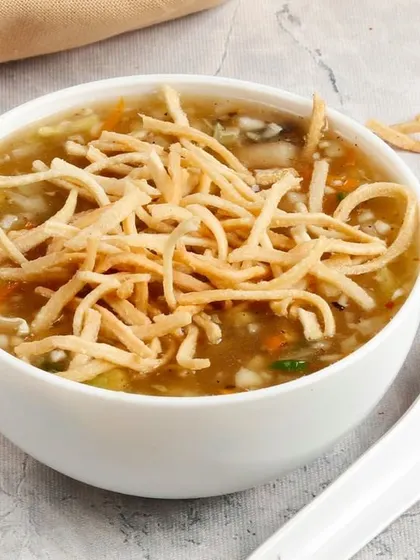 Our hot and sour Manchow Soup, a thick and flavourful soup filled with vegetables and topped with a handful of crunchy fried noodles.