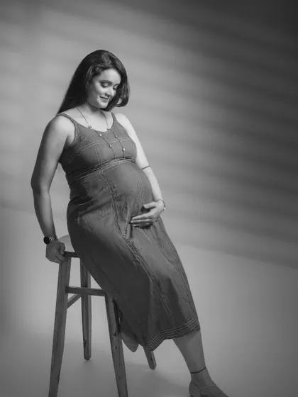 Capturing the essence of motherhood is always a special moment. This black and white portrait in a denim dress is a timeless memory.