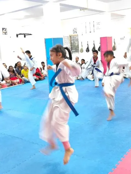 Students practicing jumping kicks.