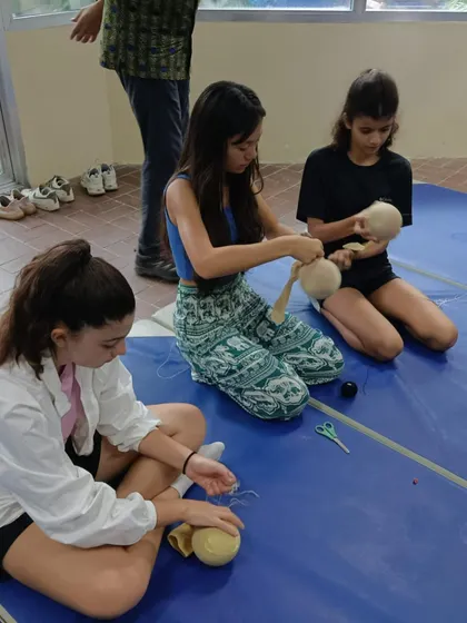 Students at the workshop in Bangladesh are busy creating their puppets. They are learning to work with fabric, thread, and other simple materials.