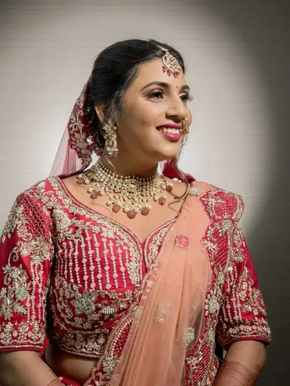 A candid moment of the bride's joyful smile. The soft glam makeup enhances her natural beauty, making her look effortlessly radiant.