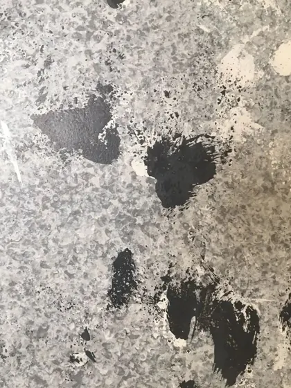 A detailed view of the black, white, and grey Drizzle texture used for a TV accent wall. The abstract pattern is bold and energetic, making it a great choice for a focal point in a room.