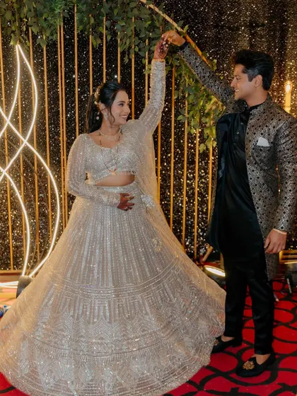 The couple sharing a dance, the bride's lehenga twirling beautifully.