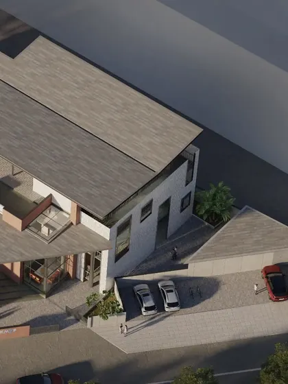 A closer aerial view of the KMYF Center highlights the building's relationship with its surroundings. The design carefully manages public access and private functions while maintaining a cohesive architectural identity.