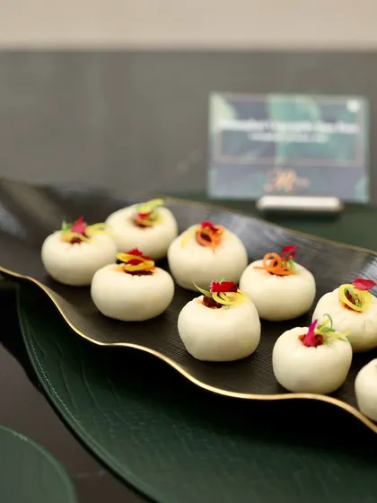 Shanghai Vegetable Bao Buns, beautifully garnished and served on a sleek black platter at the Rose Watch Bar launch.