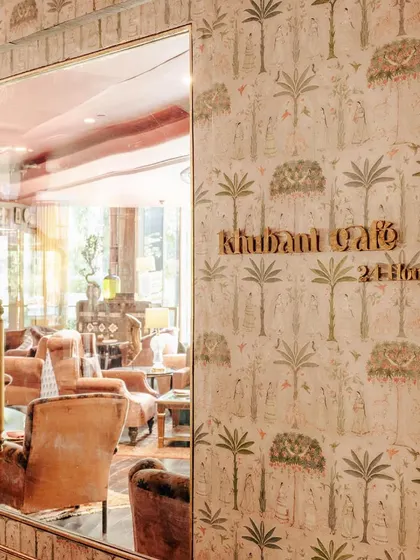 The entrance to our cafe and lounge area, where the hand-painted walls and mirrored doors promise an experience of elegance and comfort.