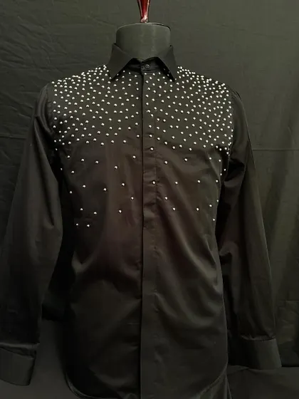 The black studded shirt. Silver studs are hand-placed across the shoulders and chest, creating a starry night effect that is both edgy and elegant.