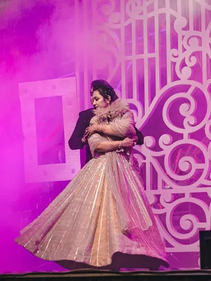 A romantic moment captured amidst the stage smoke. We use special effects to create an intimate and dreamy atmosphere for couple performances.