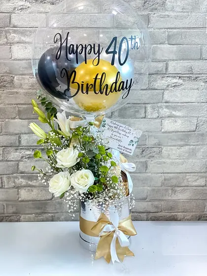 Reaching 40 is a milestone worth celebrating with style. This hamper features a personalized "Happy 40th Birthday" balloon, a fresh arrangement of white roses and lilies, and a selection of curated treats, making it a sophisticated and heartfelt gift.